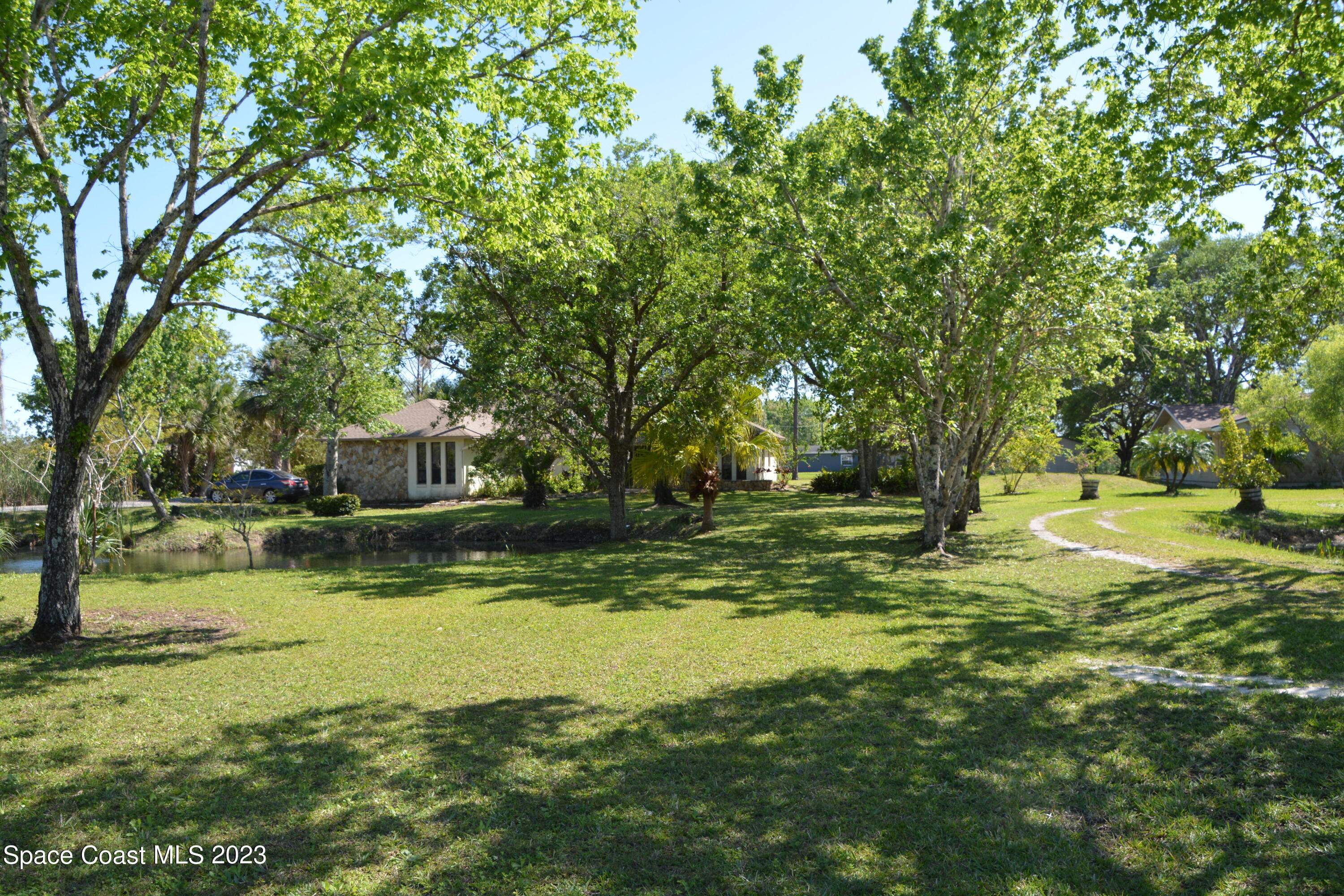 1045 Pine Island Road Merritt Island, FL 32953 - Photo 39 of 42 a view of a trees with a yard