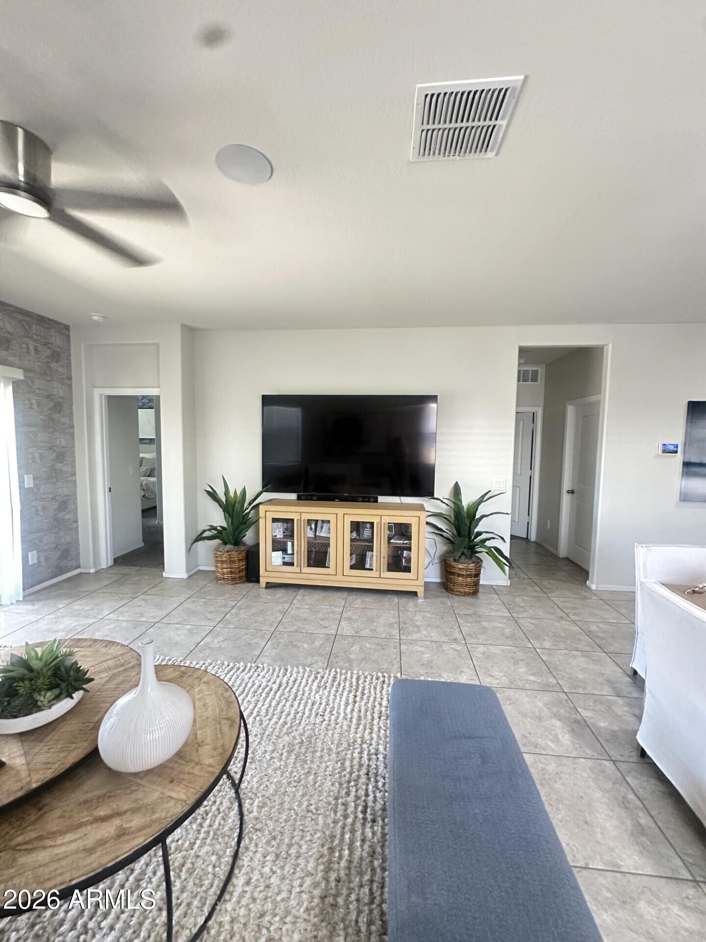 7851 West Riverside Avenue Phoenix, AZ 85043 - Photo 8 of 40 a living room with furniture and a flat screen tv