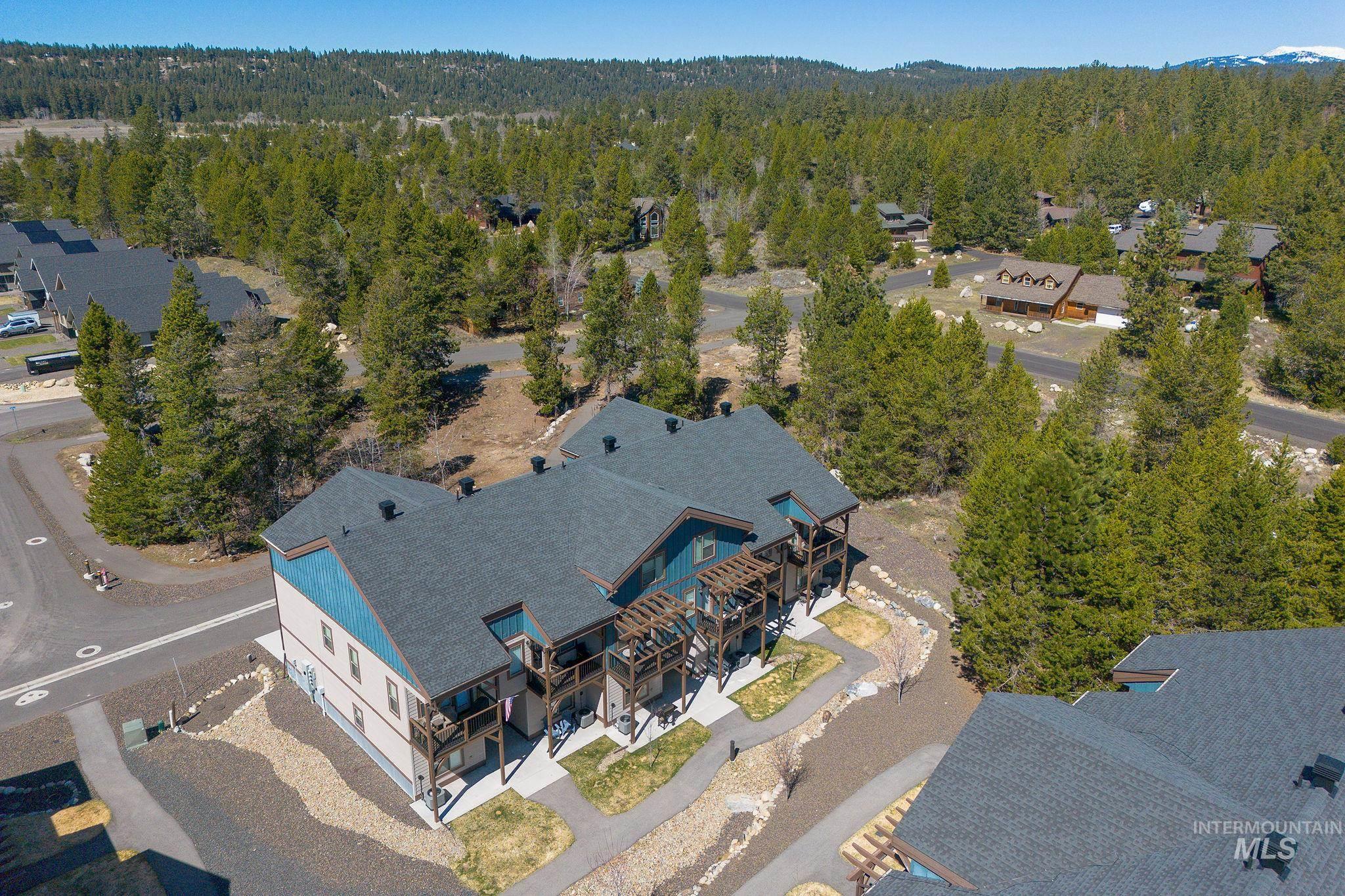 311 Broken Ridge Way McCall, ID 83638 - Photo 43 of 44 Multi-story building featuring a dark shingle roof and light blue and tan siding