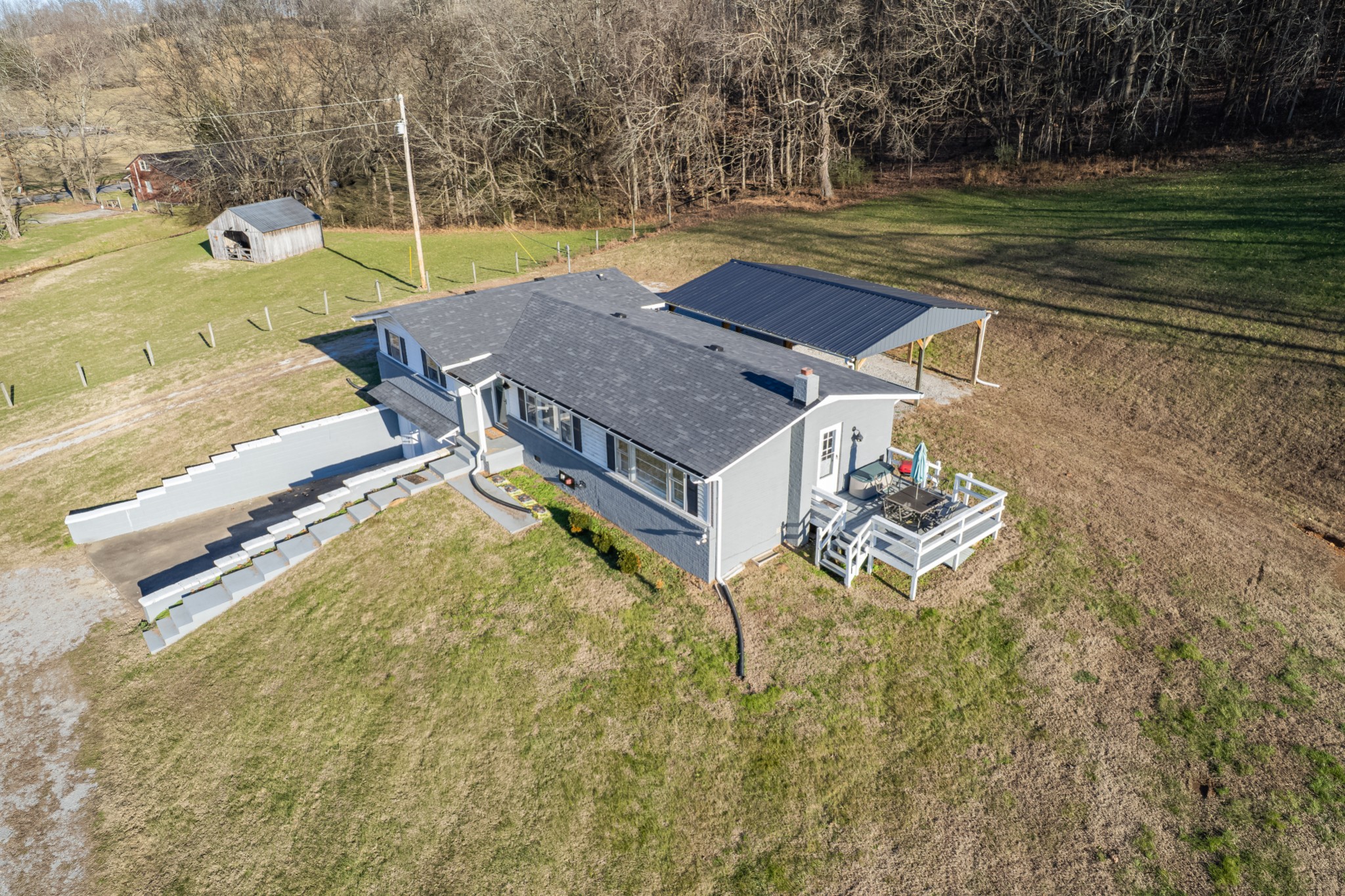 a view of a swimming pool with a yard and furniture
