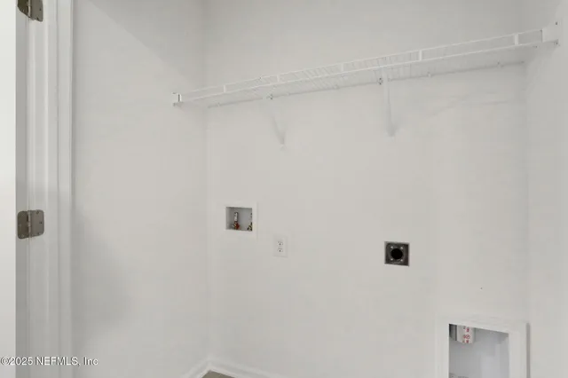 a white wall with a shower in it