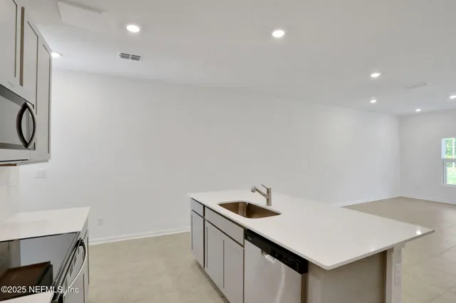 a utility room with a sink a washer and dryer