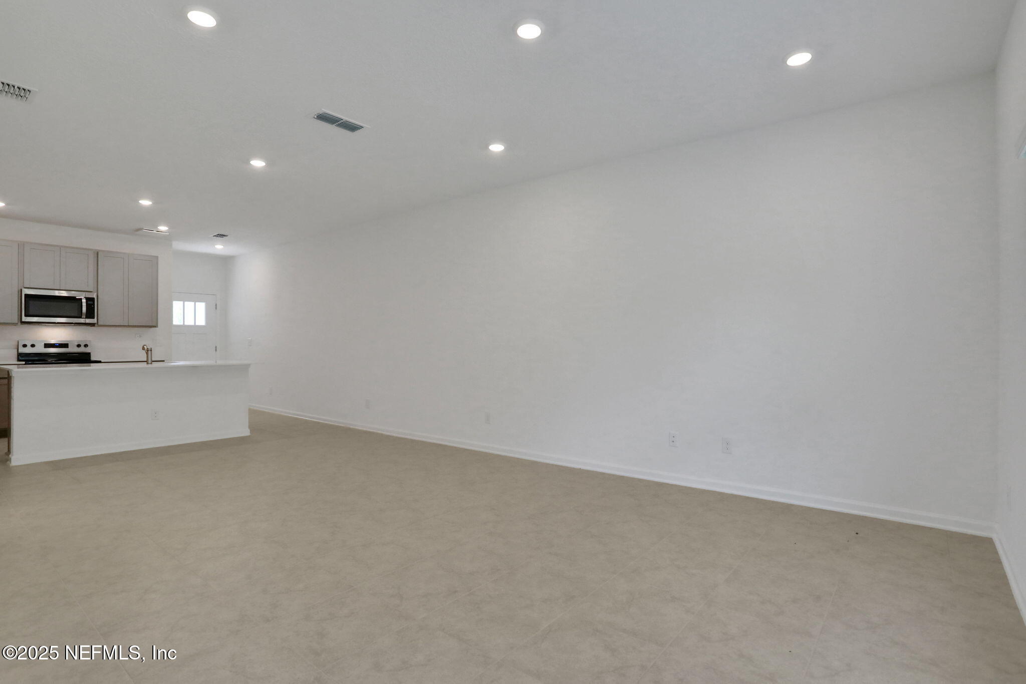 3769 Athenian Way Middleburg, FL 32068 - Photo 22 of 31 a view of an empty room with kitchen stove and a refrigerator