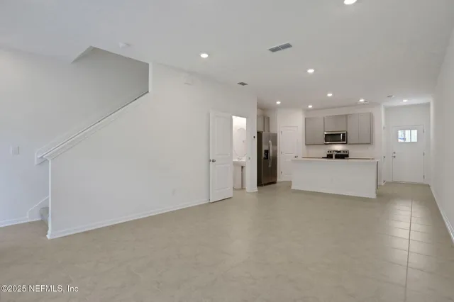 a view of a kitchen with a sink and a refrigerator
