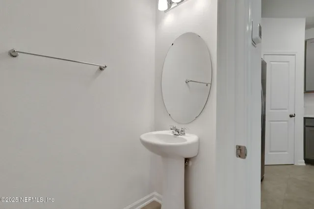 a bathroom with a sink toilet and mirror