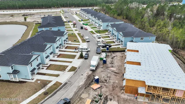 an aerial view of residential houses with outdoor space
