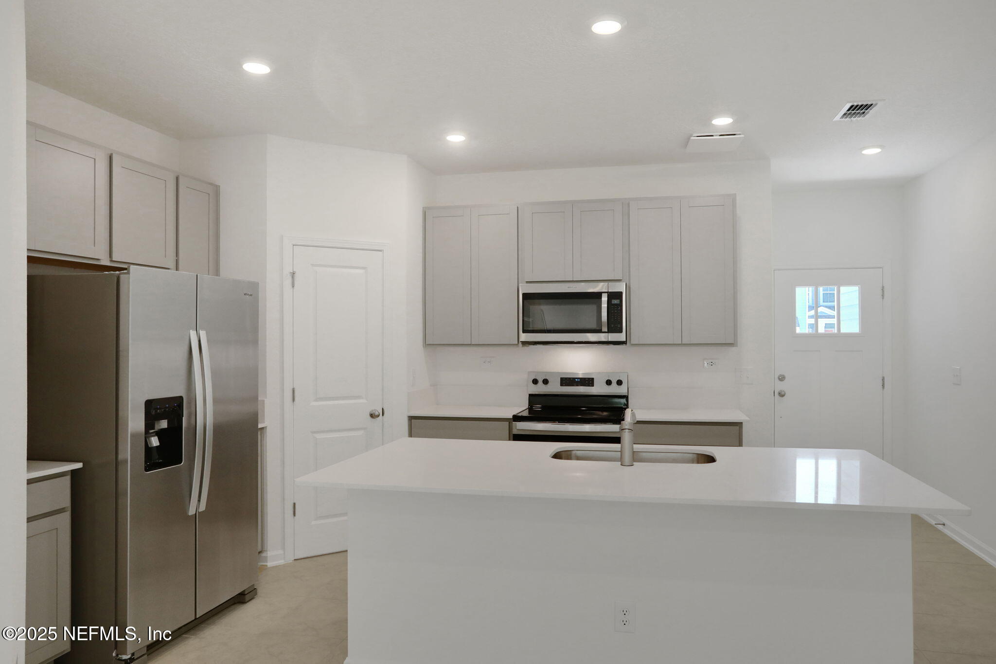 3769 Athenian Way Middleburg, FL 32068 - Photo 4 of 31 a kitchen with stainless steel appliances a refrigerator stove and microwave