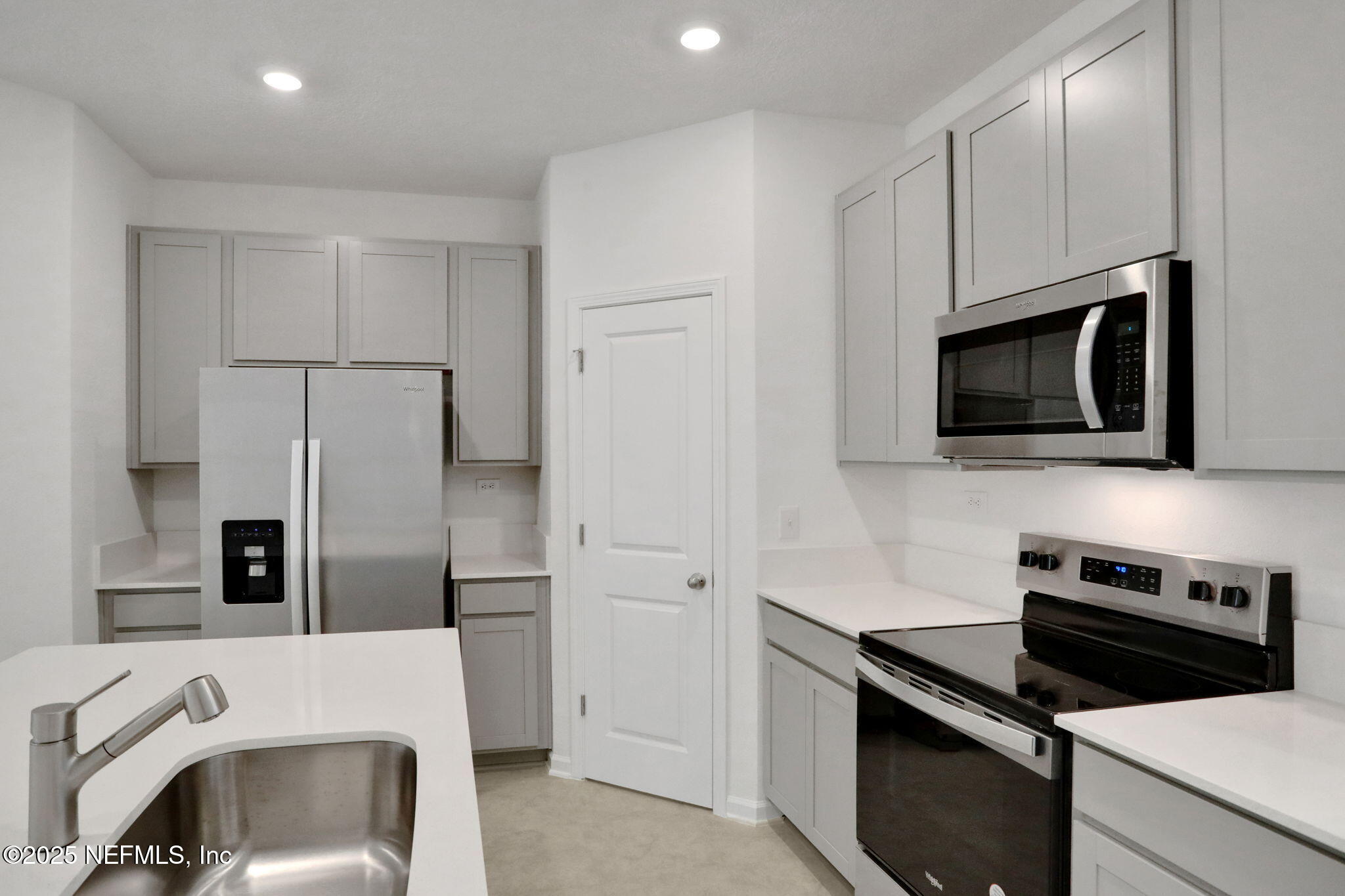 3769 Athenian Way Middleburg, FL 32068 - Photo 5 of 31 a kitchen with stainless steel appliances a stove microwave and refrigerator