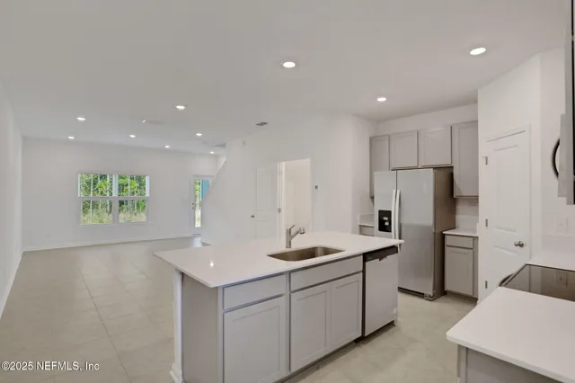 a kitchen with refrigerator and cabinets