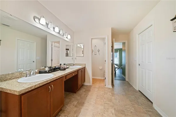 a large bathroom with a sink and a mirror