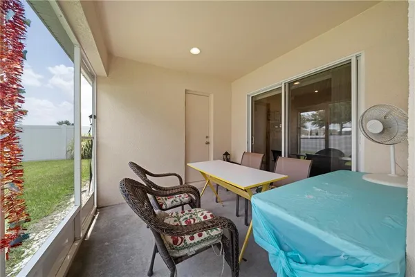 a view of a dining room with furniture and window