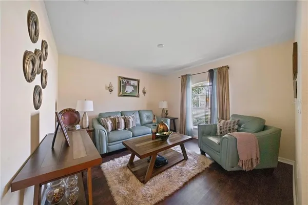 a living room with furniture and wooden floor