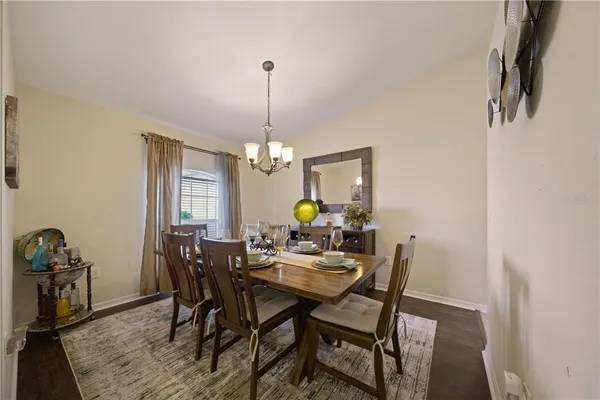a view of a dining room with furniture and wooden floor