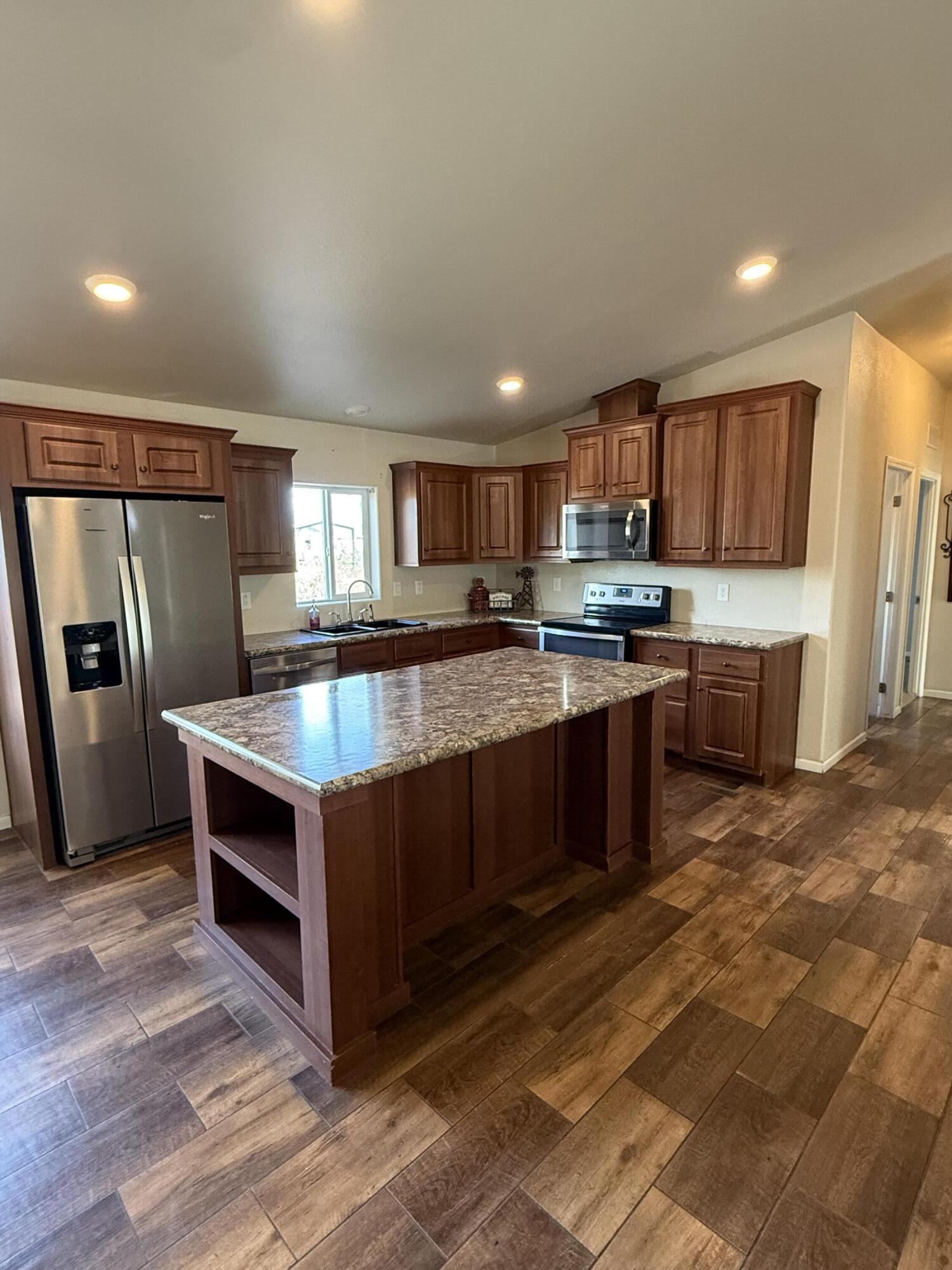 345 Old Mill Road Tonto Basin, AZ 85553 - Photo 5 of 33 a kitchen with stainless steel appliances granite countertop a stove a sink dishwasher a refrigerator and a oven