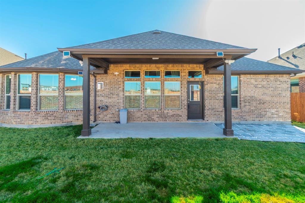 10638 Cherry Tree Way Grand Prairie, TX 76065 - Photo 32 of 39 View of the back of property featuring covered patio and plenty of yard space