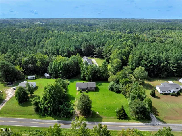 an aerial view of a house with a yard