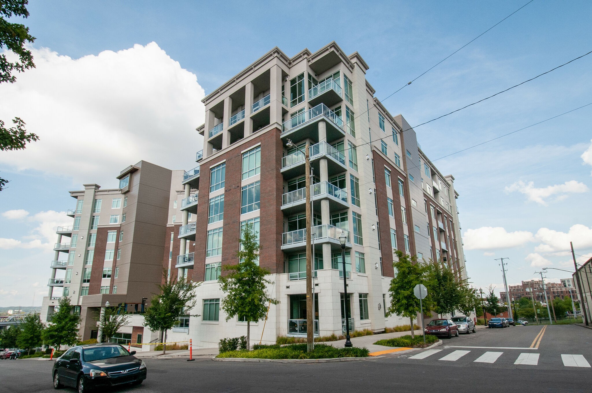 a city street lined with buildings and trees