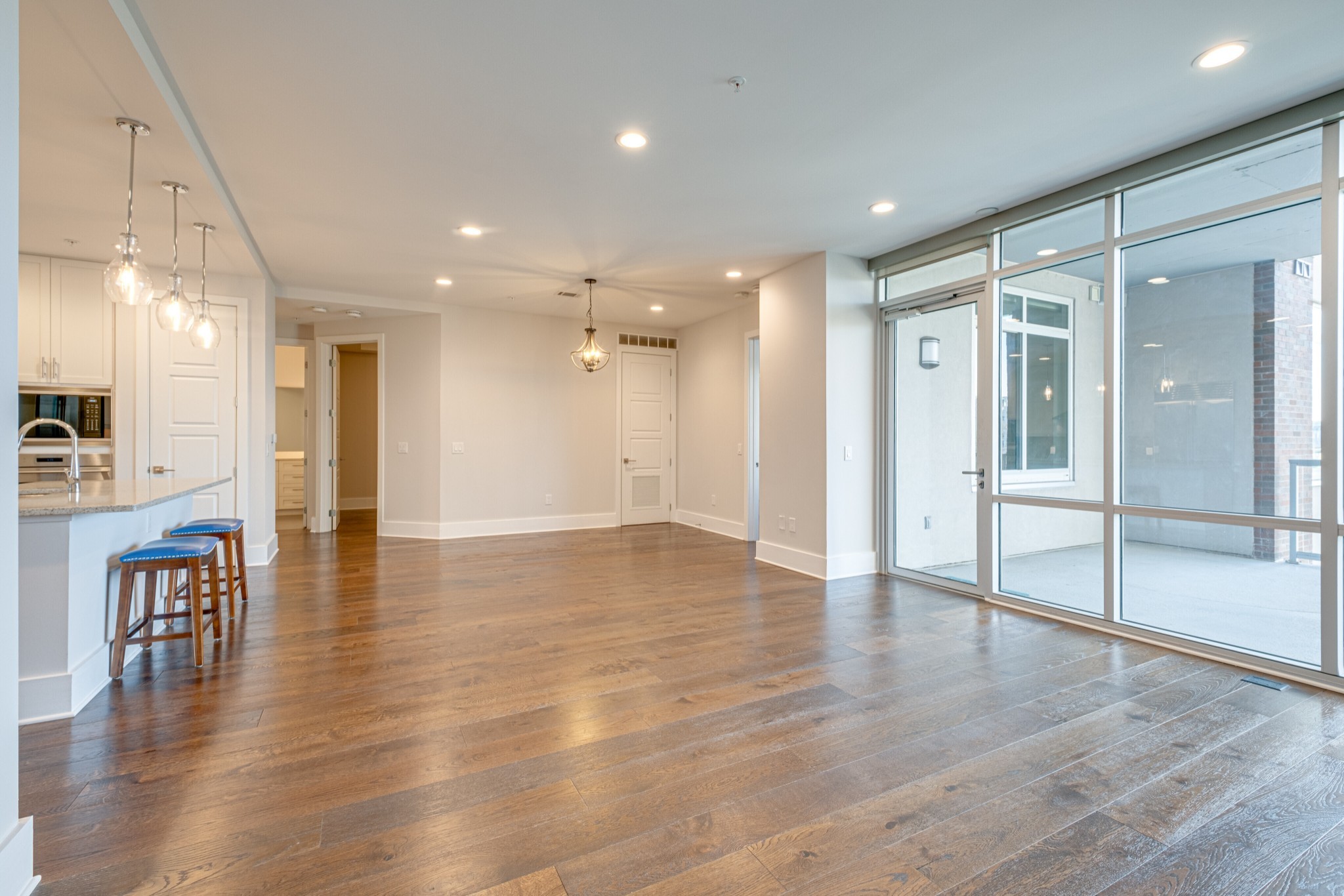 20 Rutledge Street, Unit 406 Nashville, TN 37210 - Photo 20 of 75 an empty room with wooden floor and windows