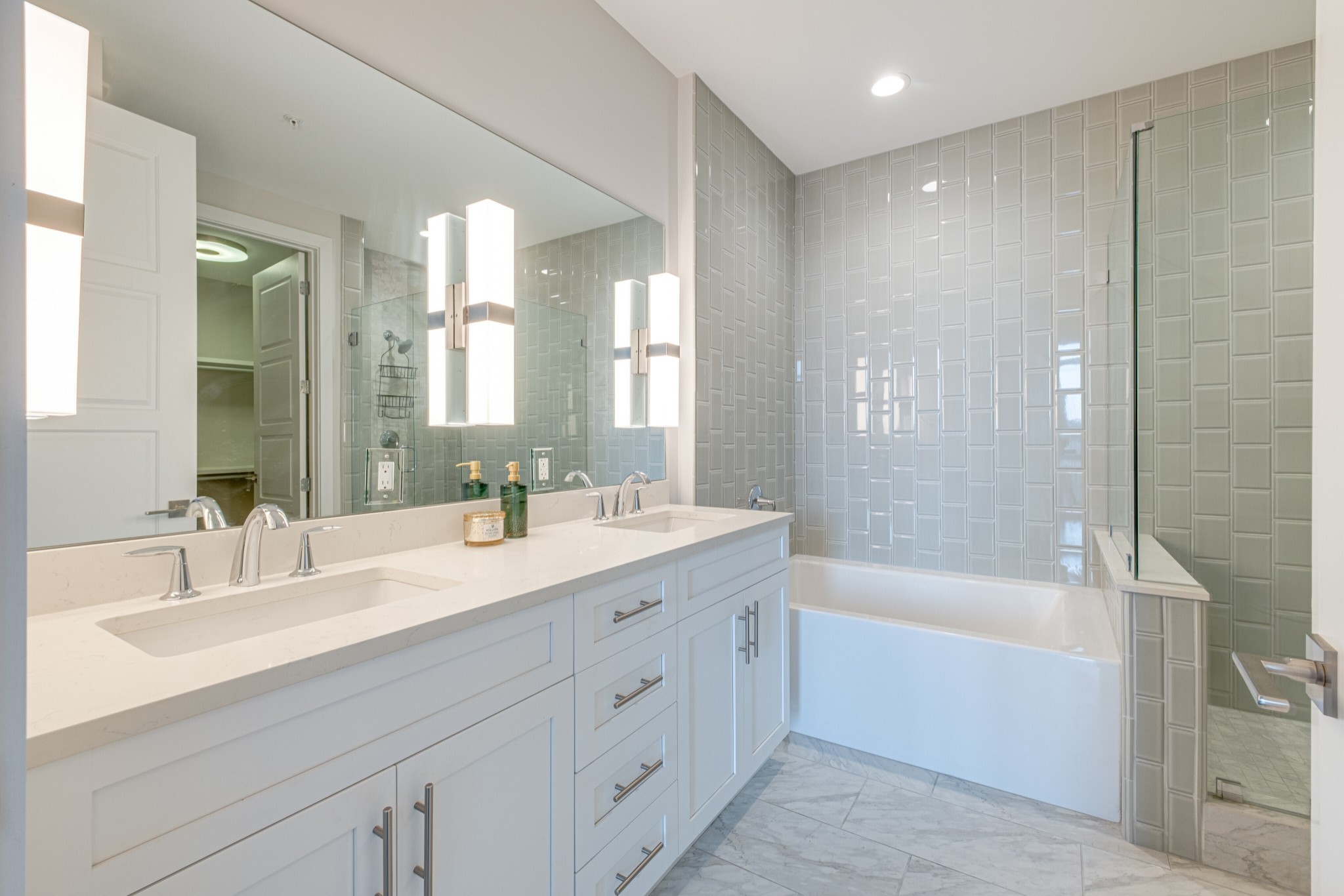 20 Rutledge Street, Unit 406 Nashville, TN 37210 - Photo 24 of 75 a bathroom with a double vanity sink mirror double and bathtub