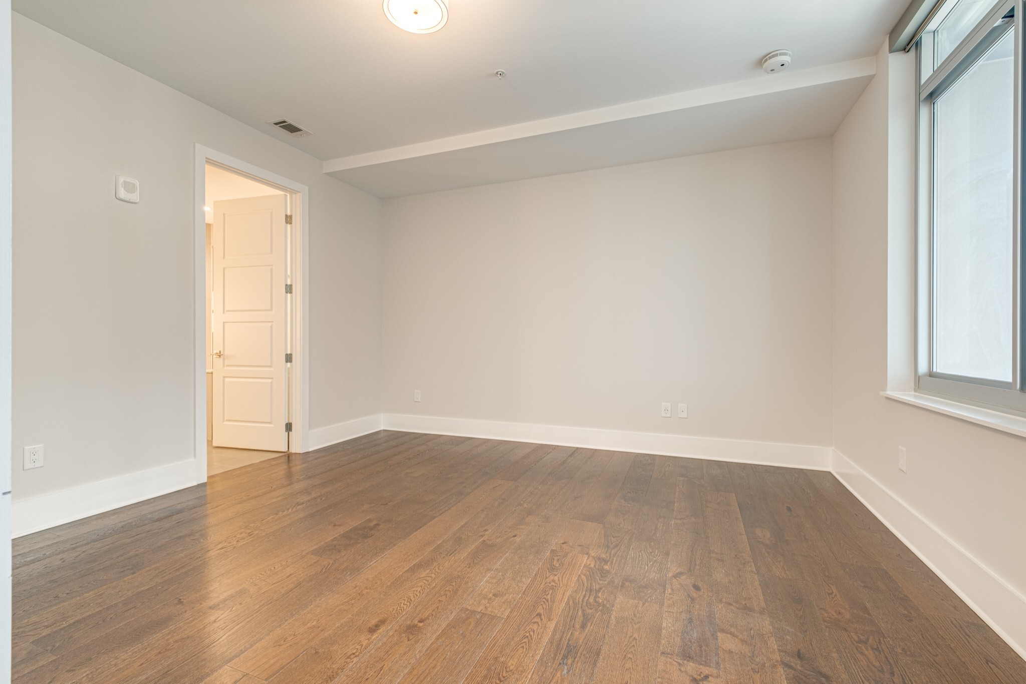 20 Rutledge Street, Unit 406 Nashville, TN 37210 - Photo 27 of 75 a view of an empty room with wooden floor and a window