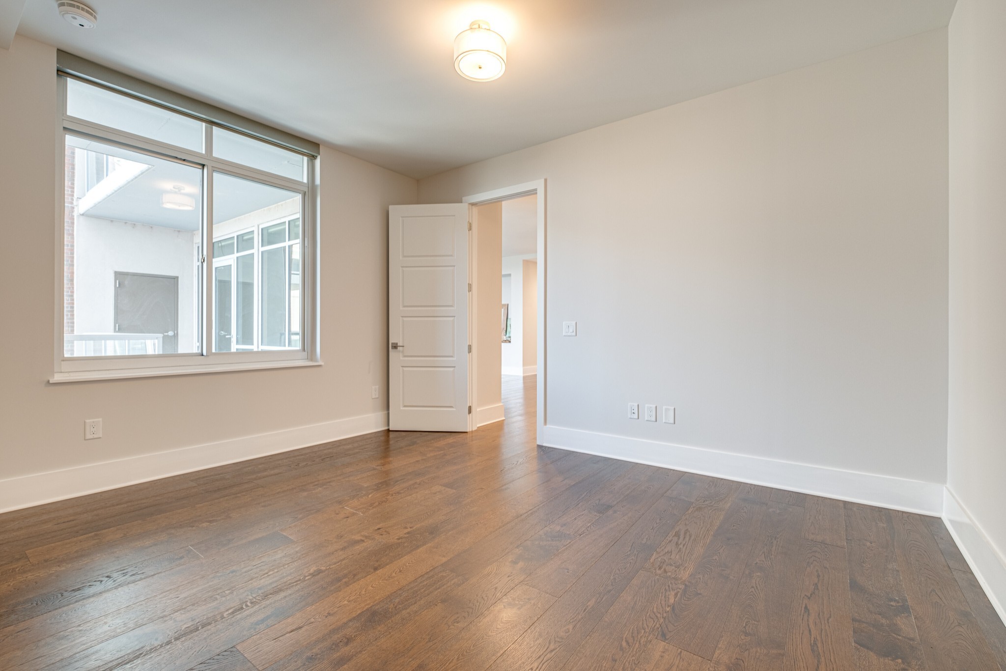 20 Rutledge Street, Unit 406 Nashville, TN 37210 - Photo 29 of 75 a view of an empty room with wooden floor and a window