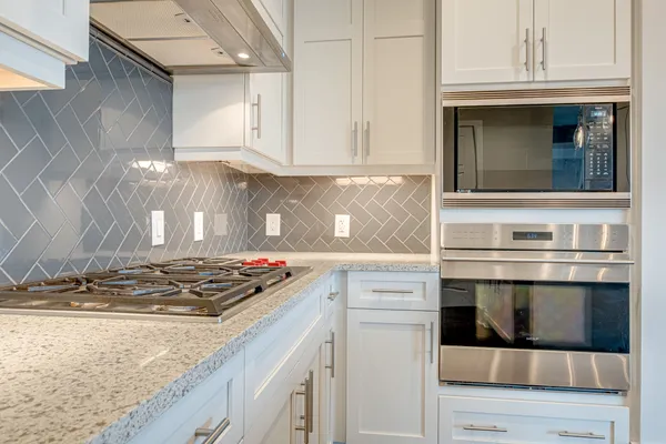 a kitchen with granite countertop a stove and a sink