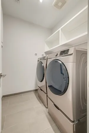 a living room with furniture a flat screen tv and a window