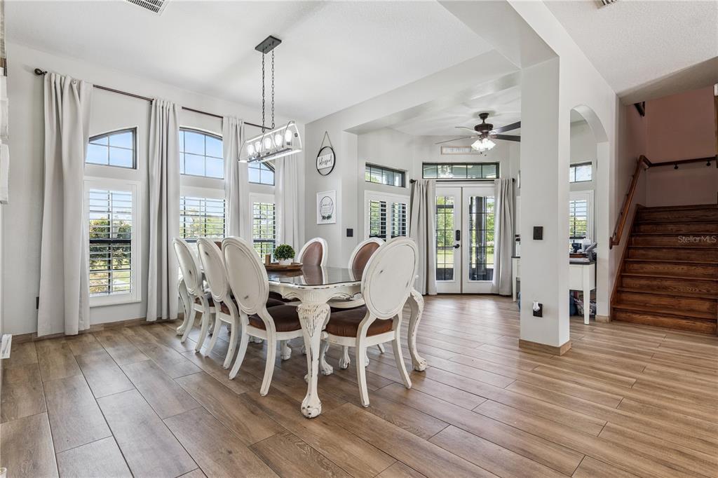 345 Cypress Isles Road Osteen, FL 32764 - Photo 9 of 41 a view of a dining room with furniture window and wooden floor