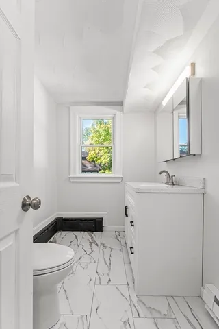 a view of a kitchen with furniture and wooden floor