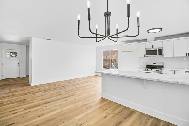a view of a kitchen with microwave and cabinets