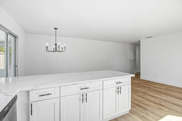 a view of a kitchen counter space a sink and dishwasher