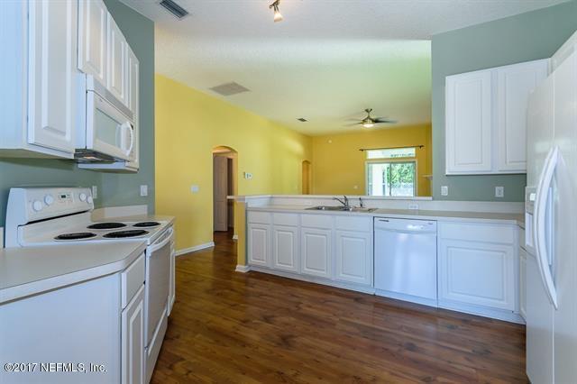 1753 Keswick Road St. Augustine, FL 32084 - Photo 7 of 26 a kitchen with granite countertop a sink a stove and cabinets