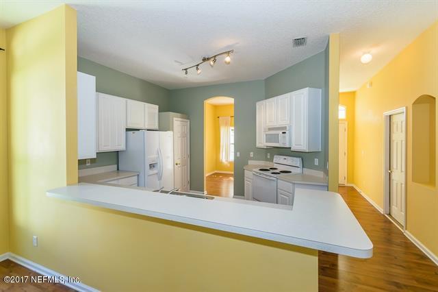1753 Keswick Road St. Augustine, FL 32084 - Photo 8 of 26 a large kitchen with a refrigerator a stove top oven a sink and dishwasher