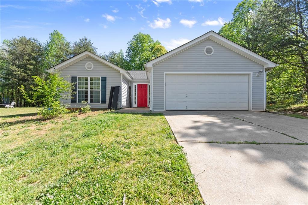 654 Marigold Lane Mount Airy, GA 30563 - Photo 1 of 27 a front view of a house with a yard and garage