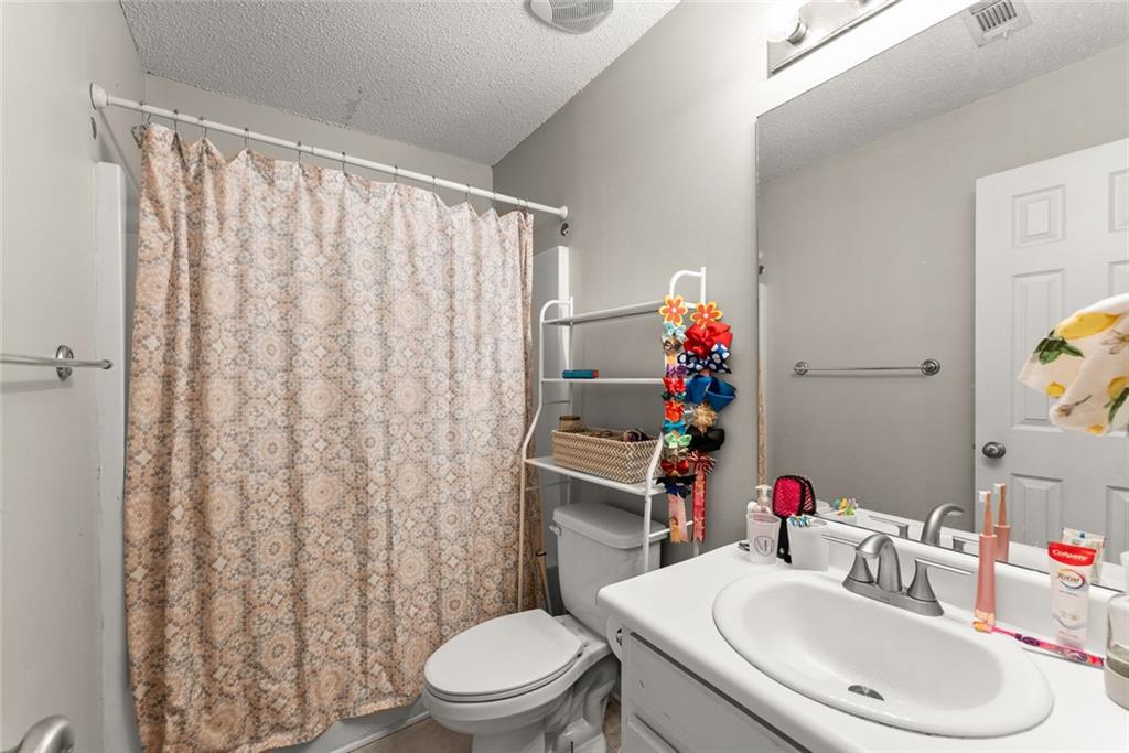 654 Marigold Lane Mount Airy, GA 30563 - Photo 13 of 27 a bathroom with a sink mirror vanity and toilet