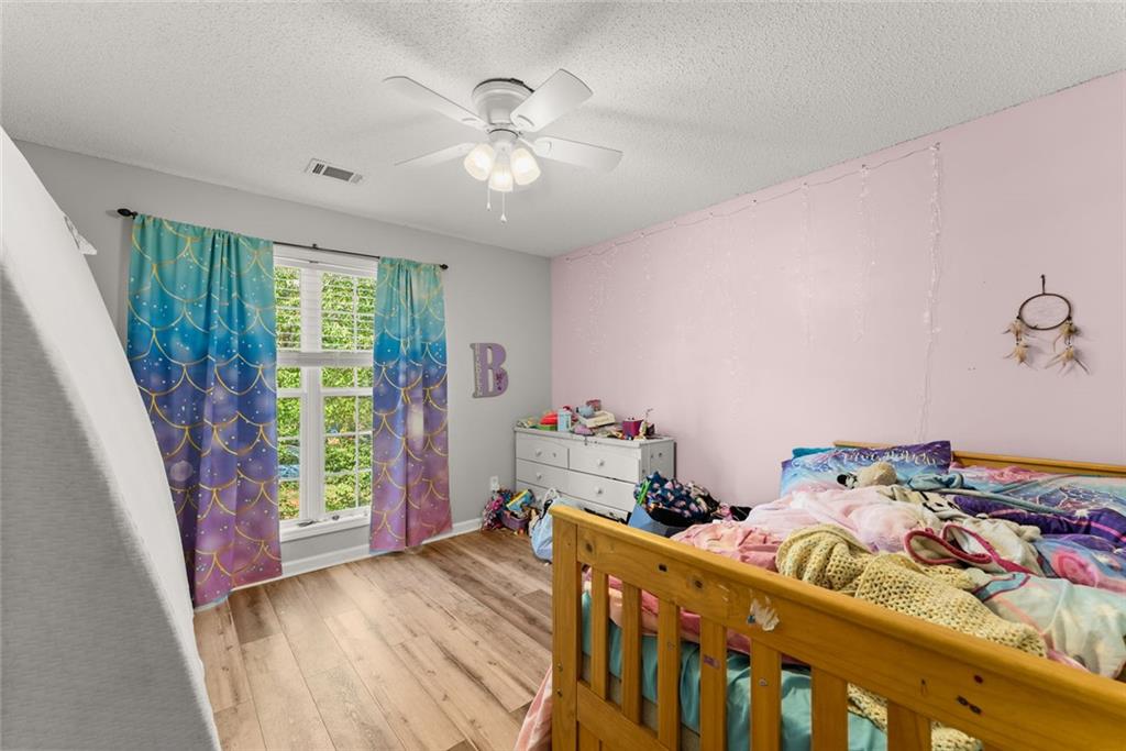 654 Marigold Lane Mount Airy, GA 30563 - Photo 14 of 27 a bedroom with a bed and a chandelier
