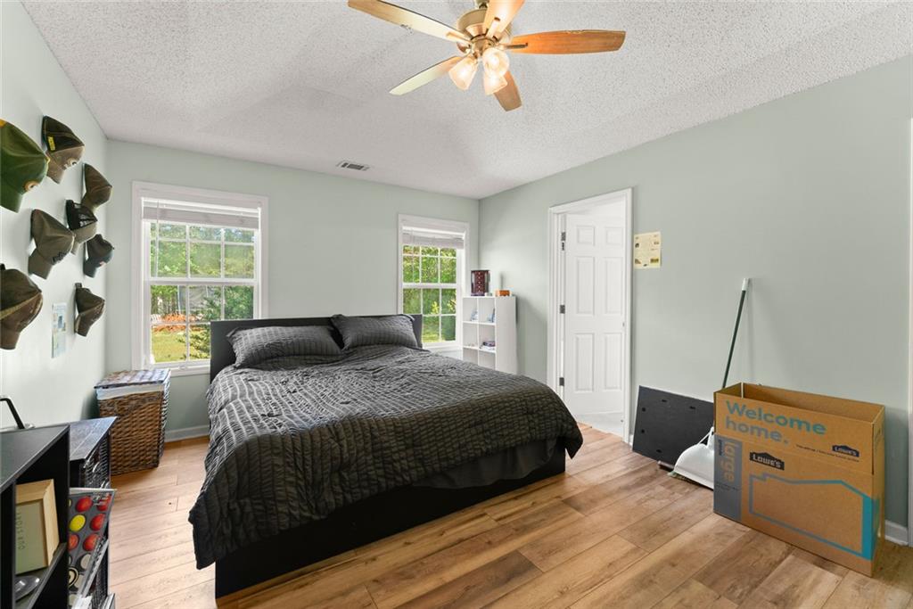 654 Marigold Lane Mount Airy, GA 30563 - Photo 16 of 27 a bedroom with a bed and a chandelier