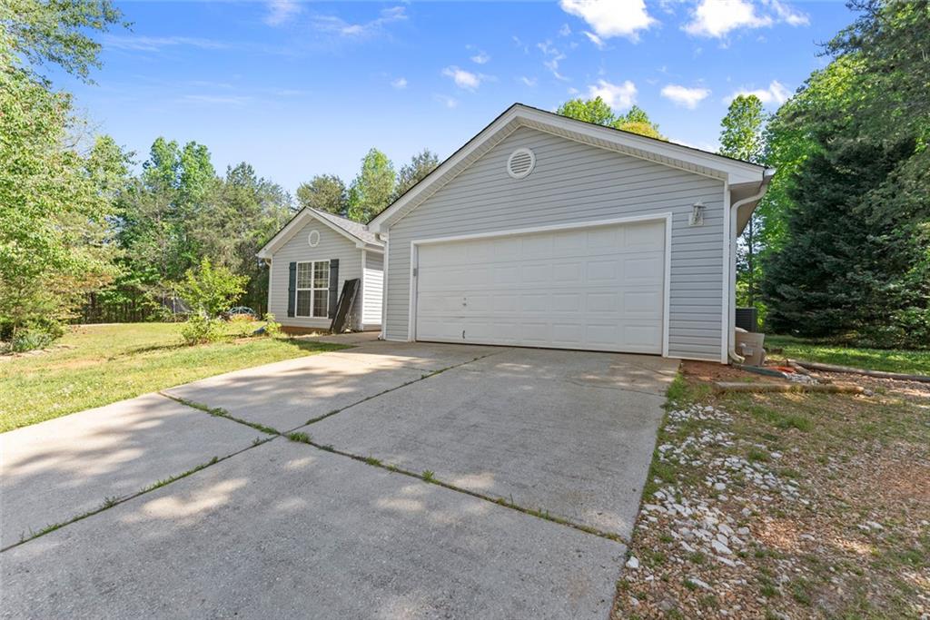 654 Marigold Lane Mount Airy, GA 30563 - Photo 2 of 27 a front view of a house with a yard and garage