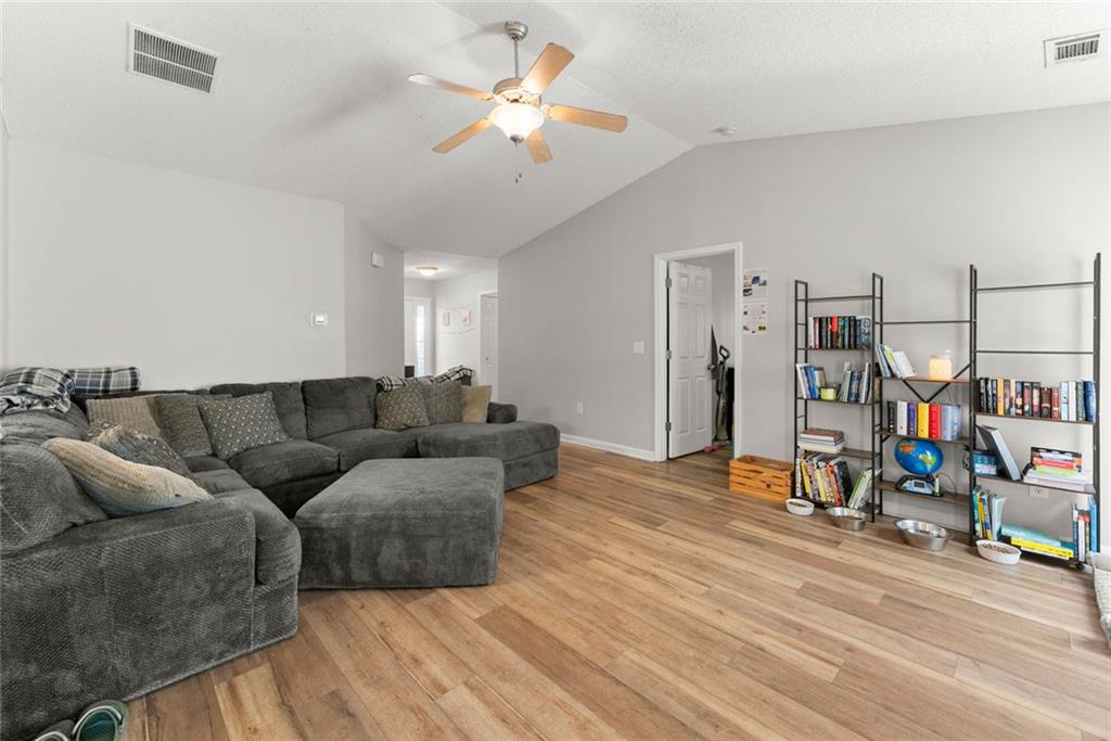 654 Marigold Lane Mount Airy, GA 30563 - Photo 5 of 27 a living room with furniture a ceiling fan and a wooden floor