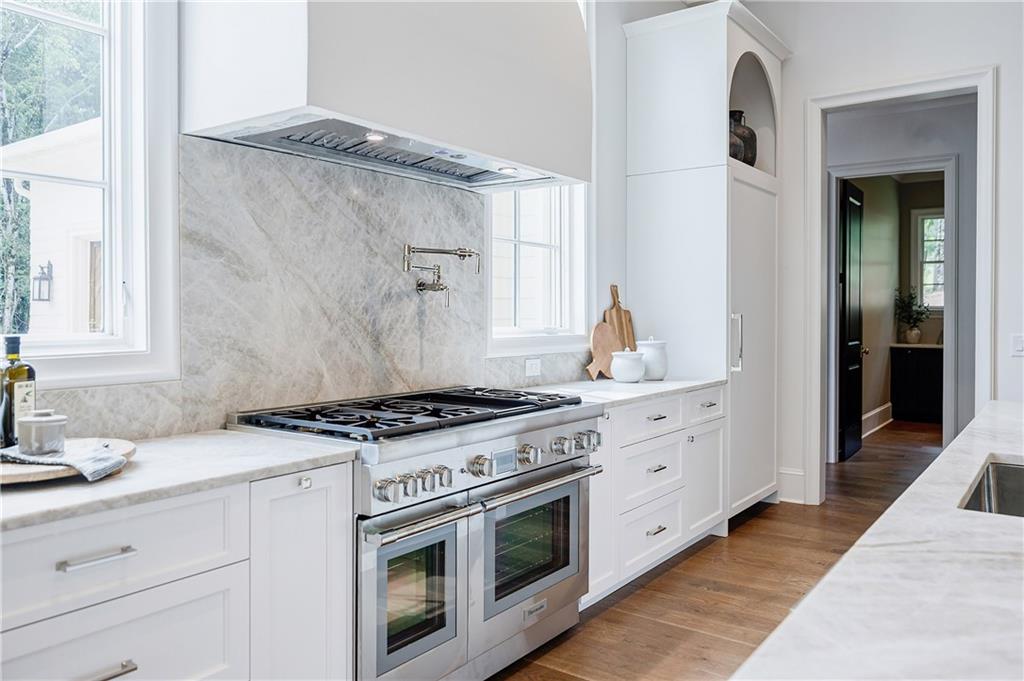 125 Laurel Brk Lane Canton, GA 30115 - Photo 13 of 50 a kitchen with stainless steel appliances granite countertop a stove and a sink