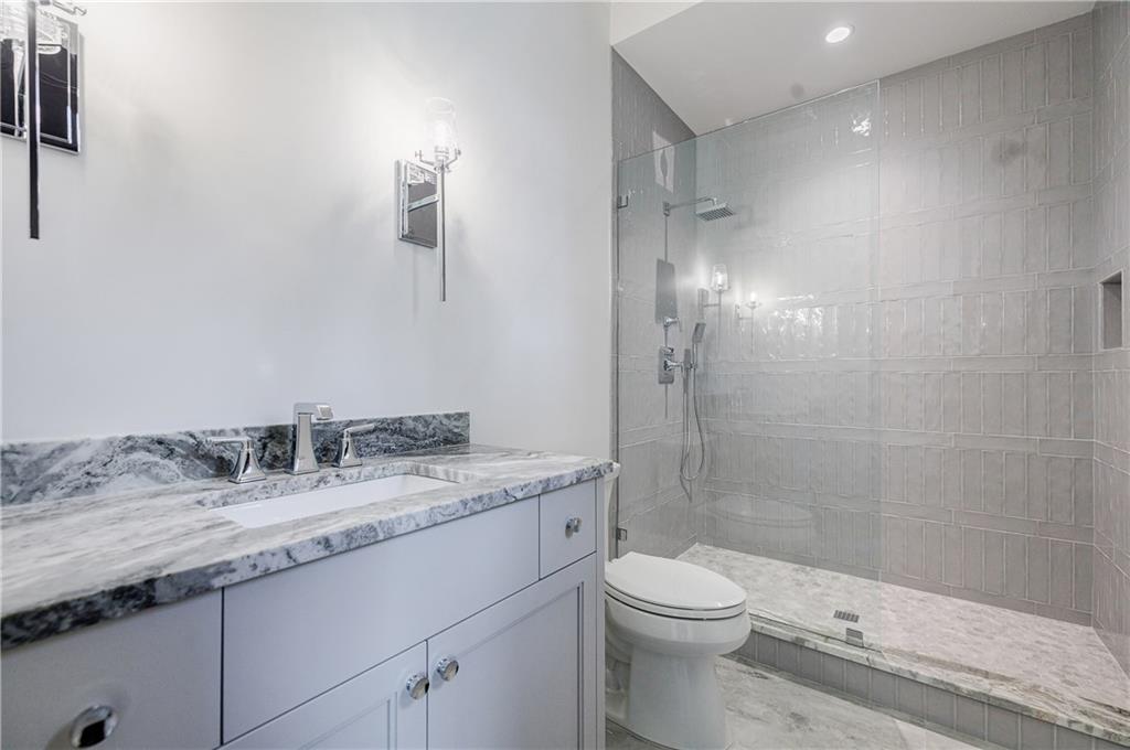 125 Laurel Brk Lane Canton, GA 30115 - Photo 30 of 50 a bathroom with a granite countertop sink toilet and shower