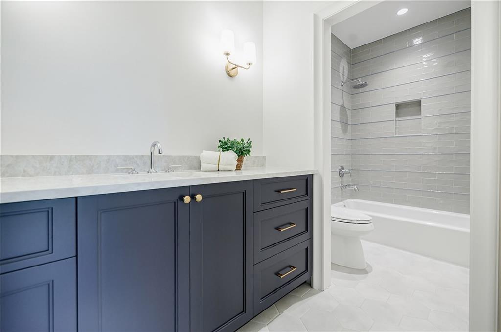125 Laurel Brk Lane Canton, GA 30115 - Photo 35 of 50 a bathroom with a bathtub sink vanity mirror and toilet