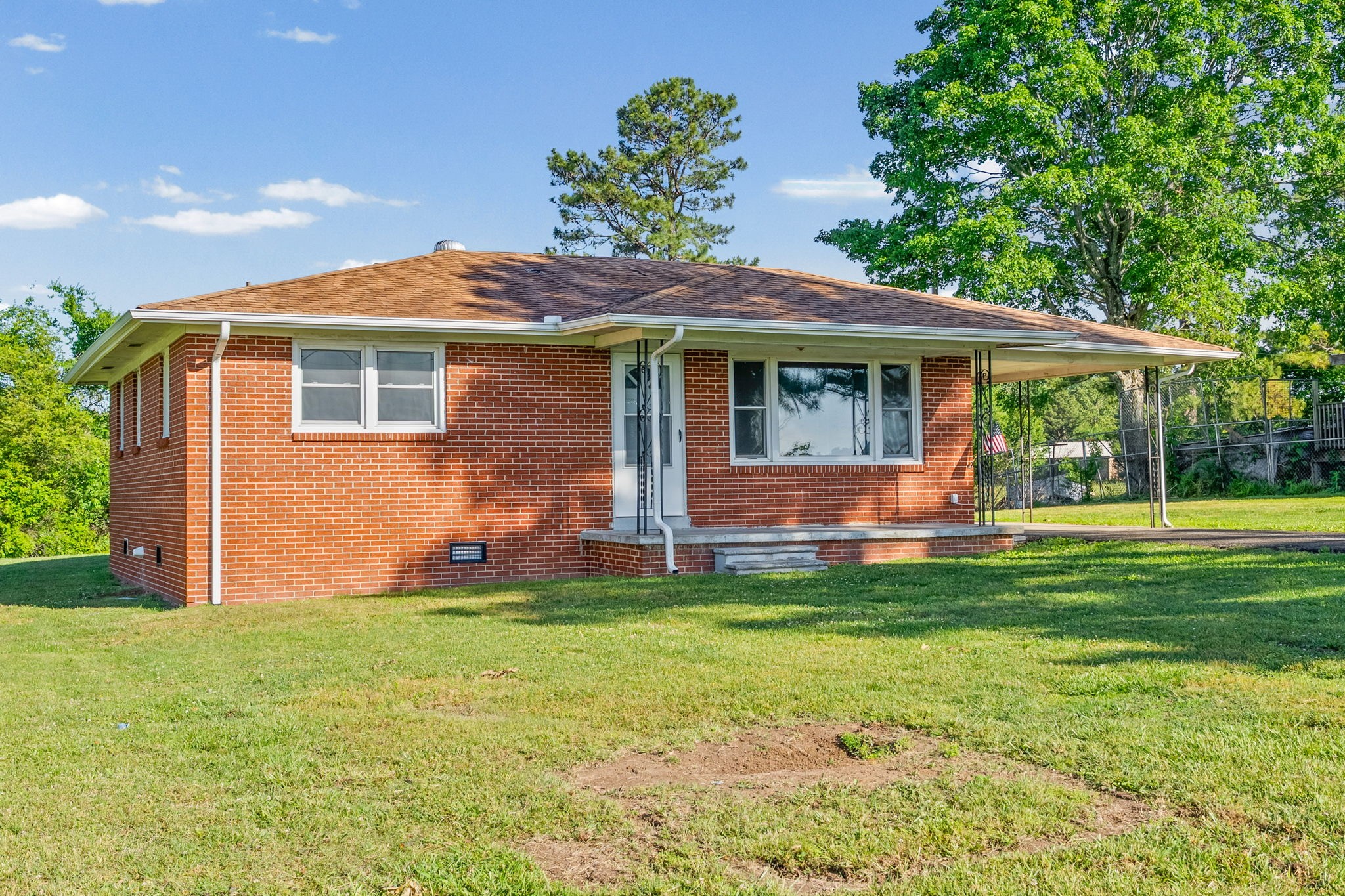a view of a house with a yard porch and sitting area
