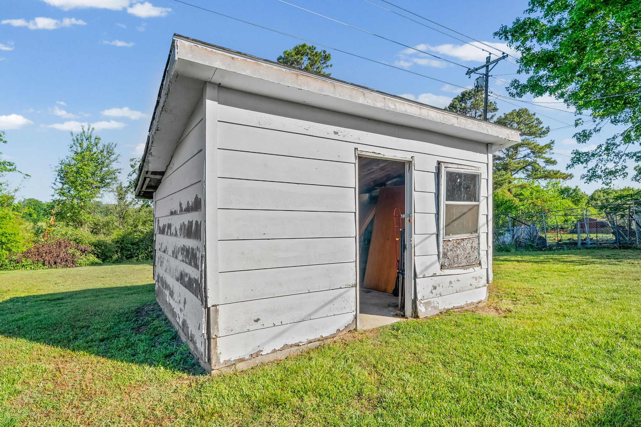 360 North Main Street Erin, TN 37061 - Photo 19 of 22 a view of a house with a backyard