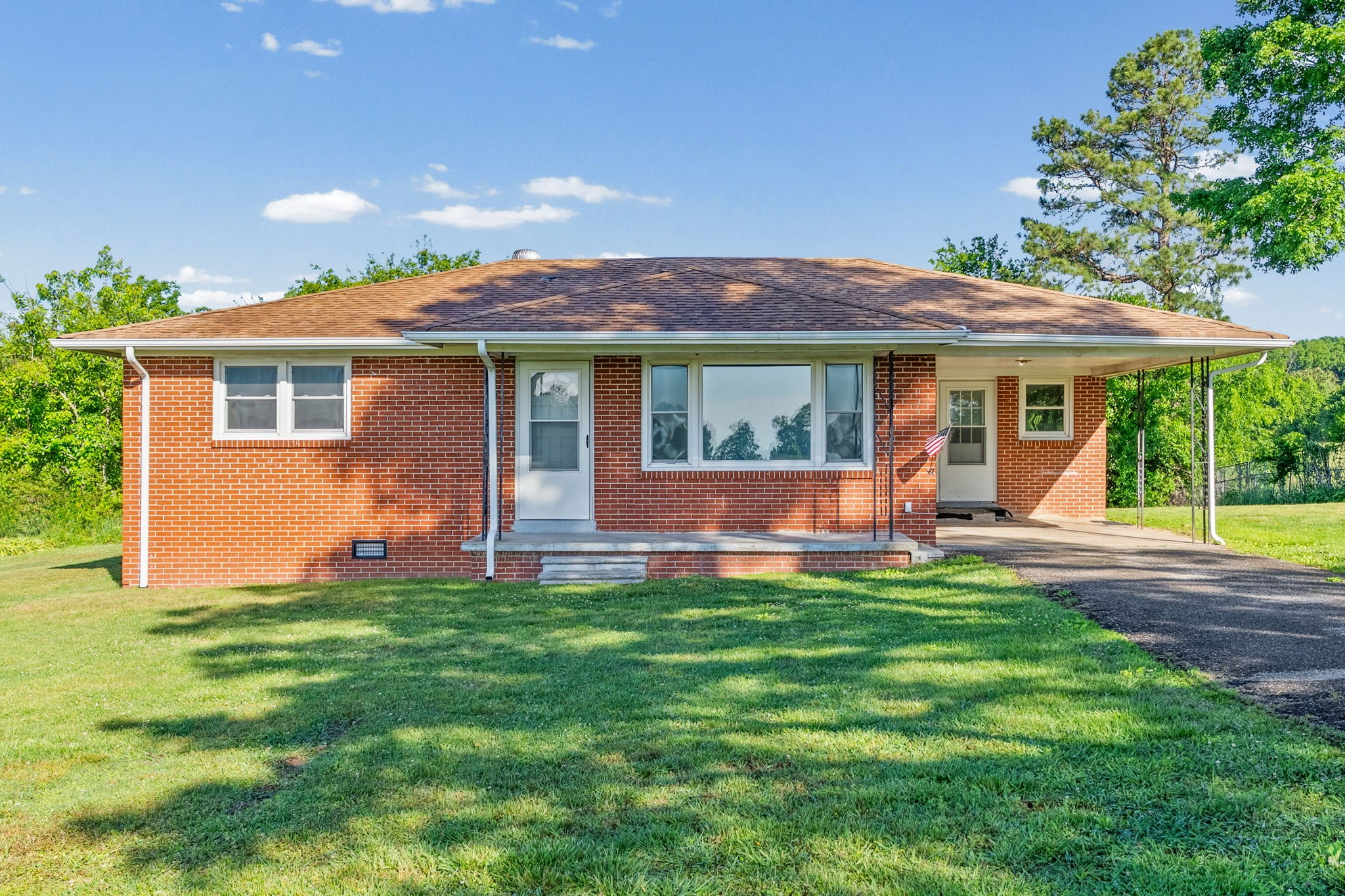 360 North Main Street Erin, TN 37061 - Photo 2 of 22 a view of a house with a backyard and a porch