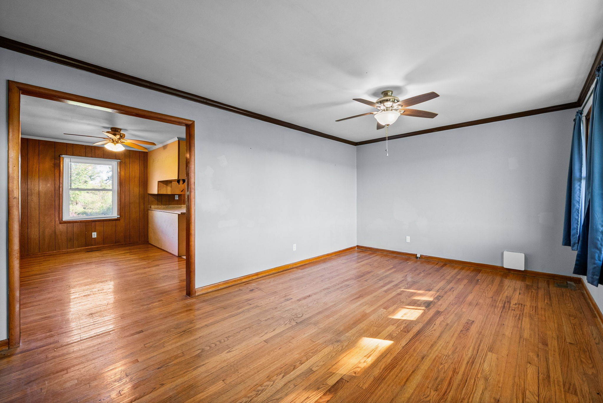 360 North Main Street Erin, TN 37061 - Photo 4 of 22 a view of empty room with wooden floor and fan