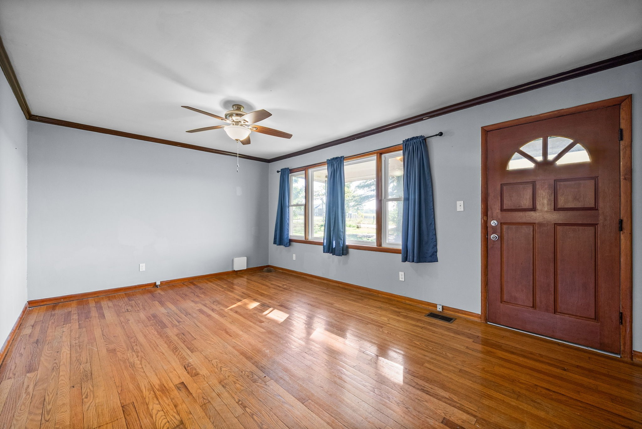 360 North Main Street Erin, TN 37061 - Photo 5 of 22 a view of an empty room with wooden floor and a window
