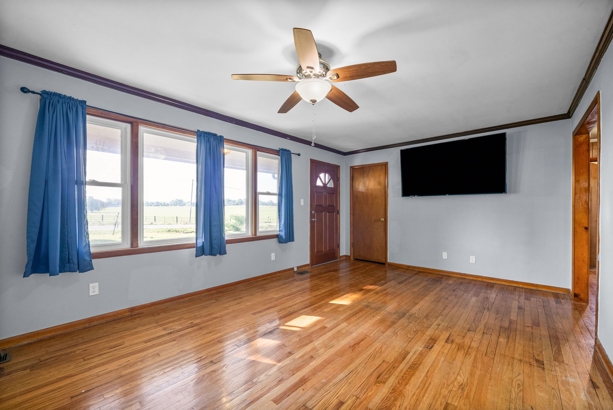 360 North Main Street Erin, TN 37061 - Photo 6 of 22 a view of an empty room with wooden floor and a window
