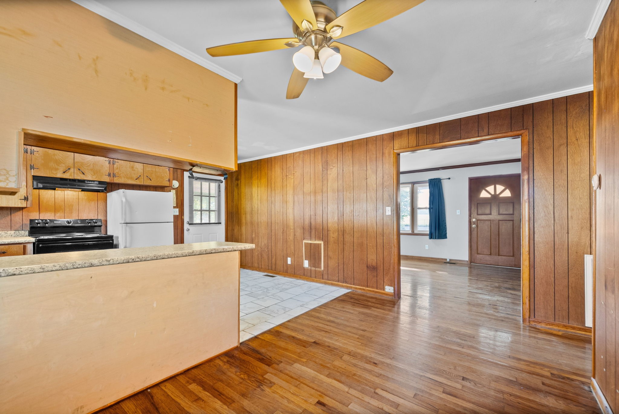 360 North Main Street Erin, TN 37061 - Photo 8 of 22 a view of a livingroom with wooden floor and a ceiling fan