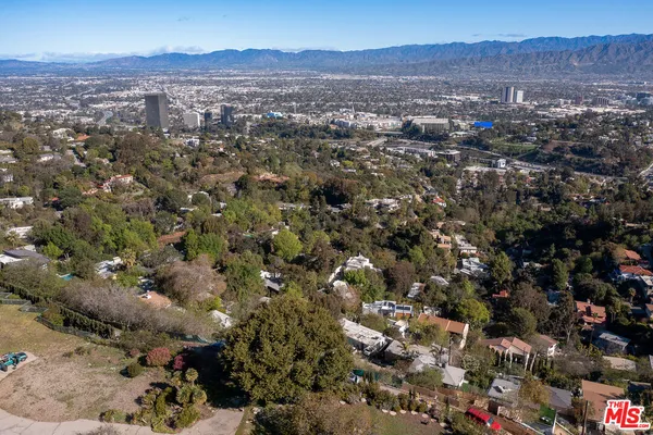 an aerial view of residential house and green space